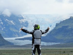 Back view of motorcyclist with thumbs up at glacier view on Iceland Adventure Motorcycle Tour